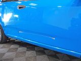 a blue car that is parked in a showroom