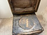 a person standing next to a chair that has a hole in it