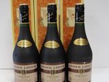 three bottles of wine sitting next to each other on a table