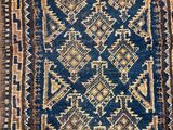 a blue and brown rug with a pattern on it