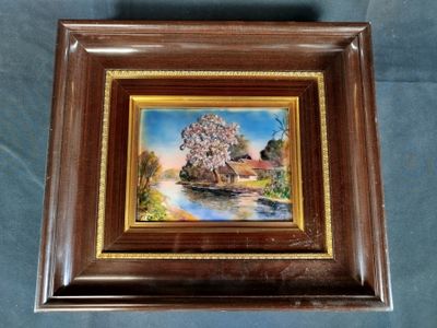 framed picture of a painting of a house and a river