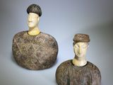pair of carved figurines of a man and a woman