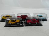 four toy cars in a display case on a white surface