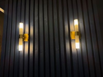 two lights that are on the side of a building