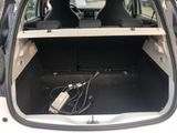 the back of a car with the trunk open and a charger in the trunk