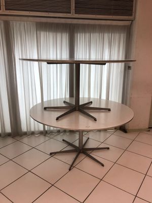 une table sur laquelle sont posées trois chaises, devant une fenêtre