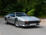 a silver sports car parked on the side of the road