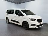 the white van is parked in a large room with a gray floor