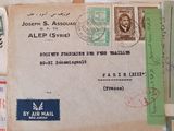 an old envelope with a lot of stamps on it sitting on top of a table