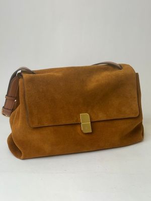 a brown sued bag with a gold buckle on the front