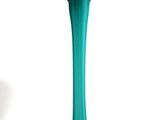 a green vase that is sitting on a white surface