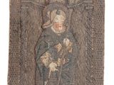 an old tapestry with a picture of a woman holding a child