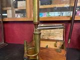 a small brass object sitting on a table next to a glass case