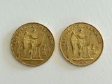 two gold coins with the image of a man and a woman on them