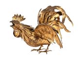 une statue de coq en or sur fond blanc