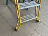 a yellow ladder that is sitting on the floor
