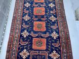 rug on the floor in a room with a white wall
