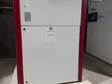 a white refrigerator with a red door in a room