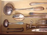 a lot of spoons and spoon knives in a box