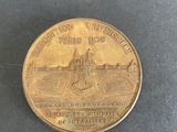 an image of a gold coin with a picture of a castle on it