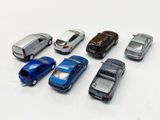 several toy cars are lined up in a row on a white surface