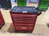 a red tool cabinet with a black top and a black drawer