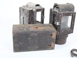 two old cameras sitting next to each other on a white surface