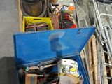 a blue box full of assorted items sitting on a pallet