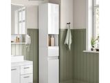 a picture of a bathroom with green walls and a white cabinet