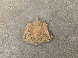 a silver book with a gold emblem on it