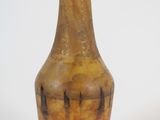 a glass bottle with a painting on it on a white surface
