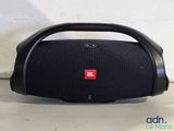 a close up of a speaker on a table near a wall
