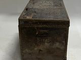 an old wooden box sitting on top of a white surface