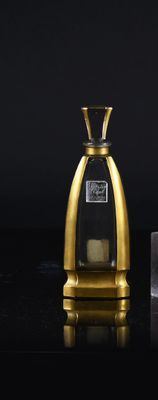 two bottles of perfume sitting on top of a table next to an ice block