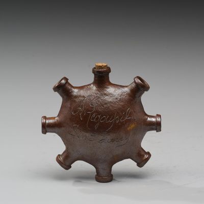 un vieux vase en bronze orné d'un motif décoratif sur le dessus