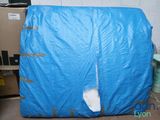 a blue tarp on top of a box in a room