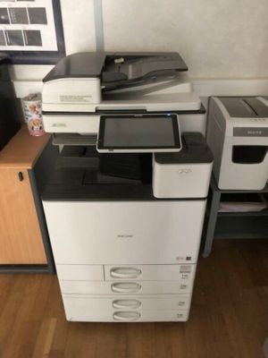 a printer sitting on top of a desk next to a printer