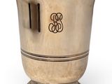an antique silver wine cooler with a monogram on the side