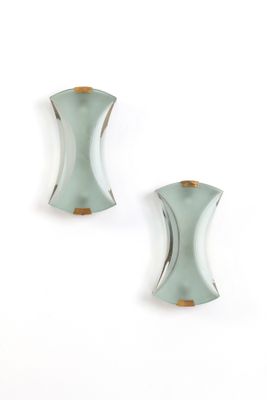 two pieces of glass on a white surface with a white background