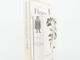 two books sitting on top of each other on a white surface