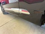 a close up of a car door handle with a sticker on it