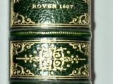 a close up of a roll of green and gold colored thread
