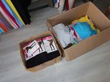 two boxes that have clothes in them on the floor