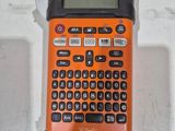 a calculator sitting on top of a table with a piece of paper underneath it