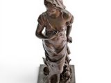 bronze statue of a woman with a dog and a cat
