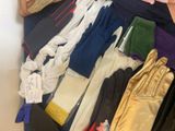 many pairs of gloves and gloves sitting on a table
