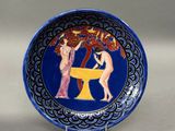 a blue plate with a picture of two women on it