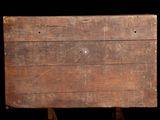 an old wooden board on a stand against a black background