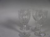 two empty wine glasses sitting on a white surface