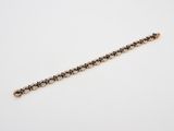 un bracelet en or serti de diamants noirs et blancs